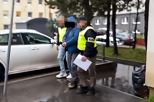 funkcjonariusze prowadzą osobę